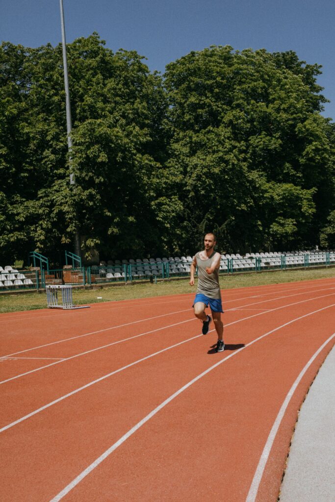 Man running on an athletics track